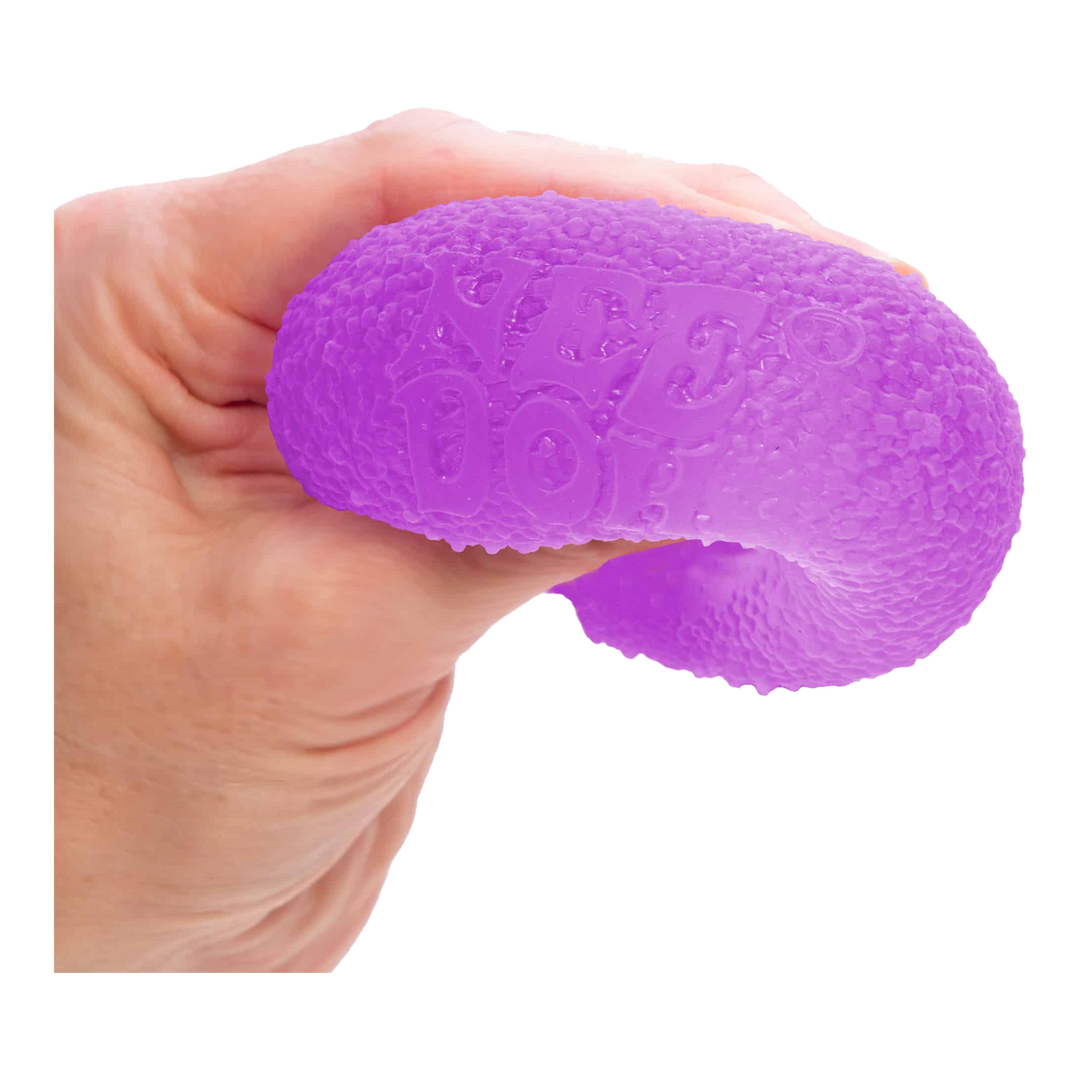 HypeSelection NeeDoh Gumdrop Purple being squeezed in a hand to show its firm sensory squish.