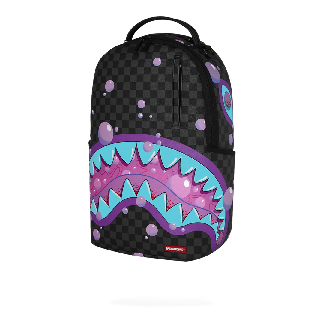 HypeSelection Sprayground Purple Slime Takeover backpack with checkerboard pattern and shark mouth graphic.