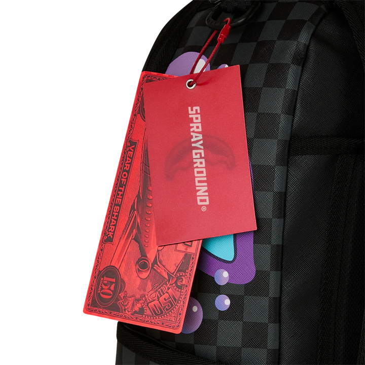 HypeSelection Sprayground Purple Slime Takeover backpack with checkerboard pattern and graphic details.