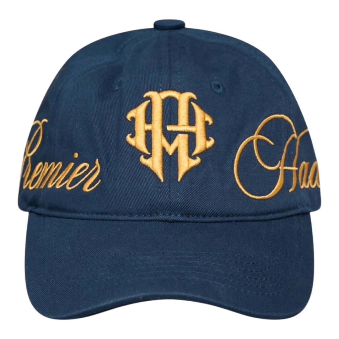 HADES Studio blue navy unstructured dad cap with gold embossed typography on front and side panels. Adjustable metal buckle closure.