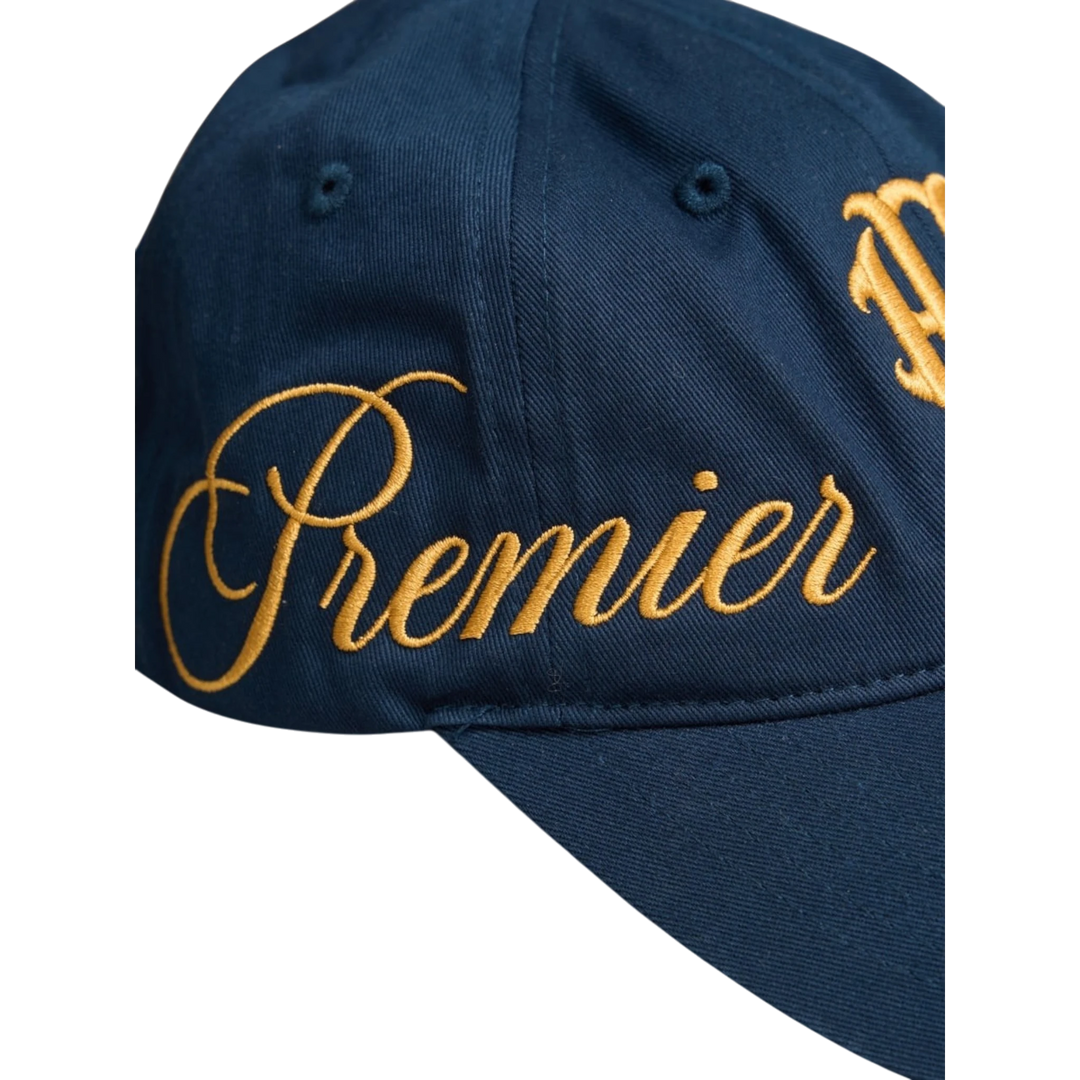 HADES Studio blue navy dad cap with gold embroidered "Premier" text on the side and "HADES" on the front. Made from Denim Khaki.