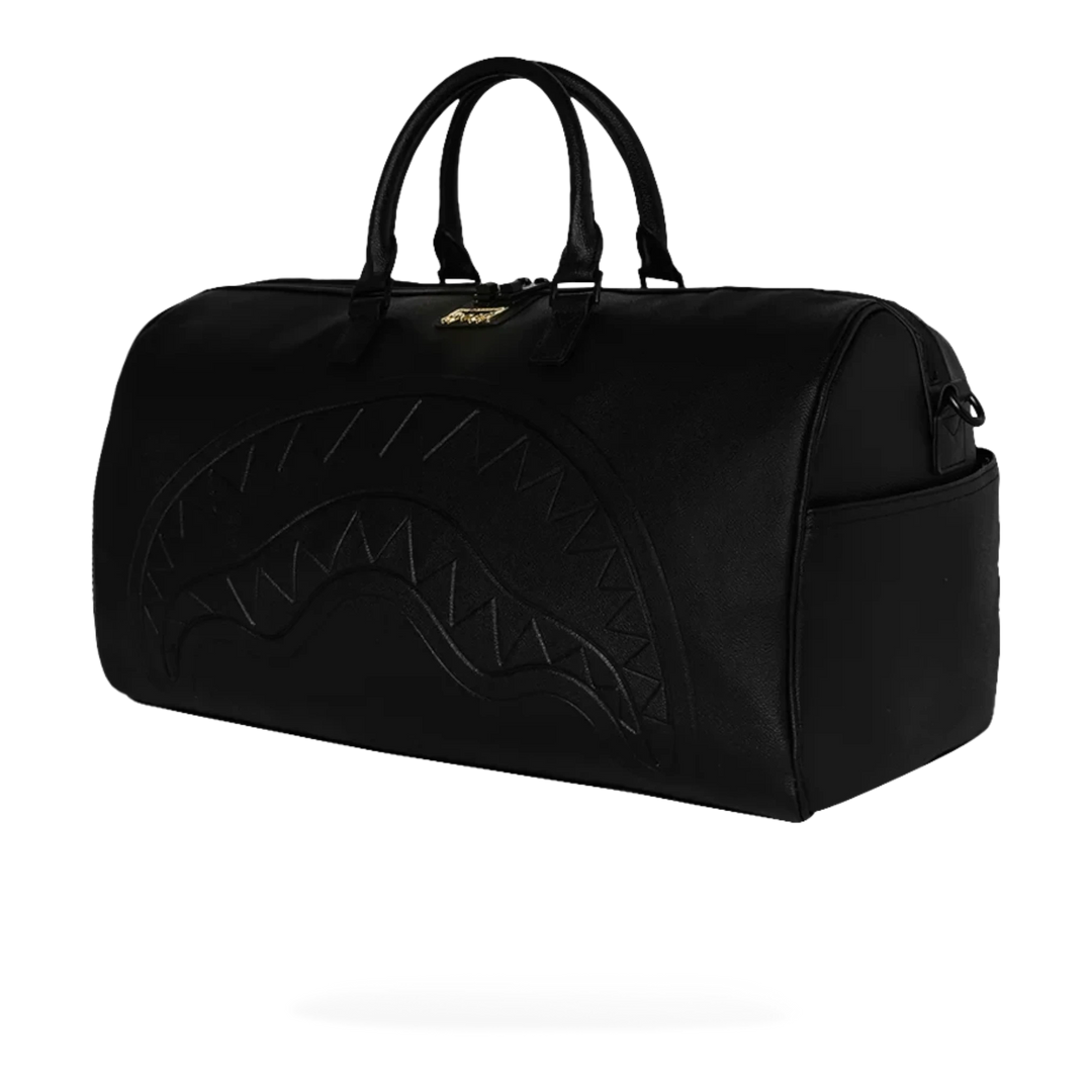 HypeSelection black eco-leather duffle bag with embossed shark mouth design and gold zipper detail.