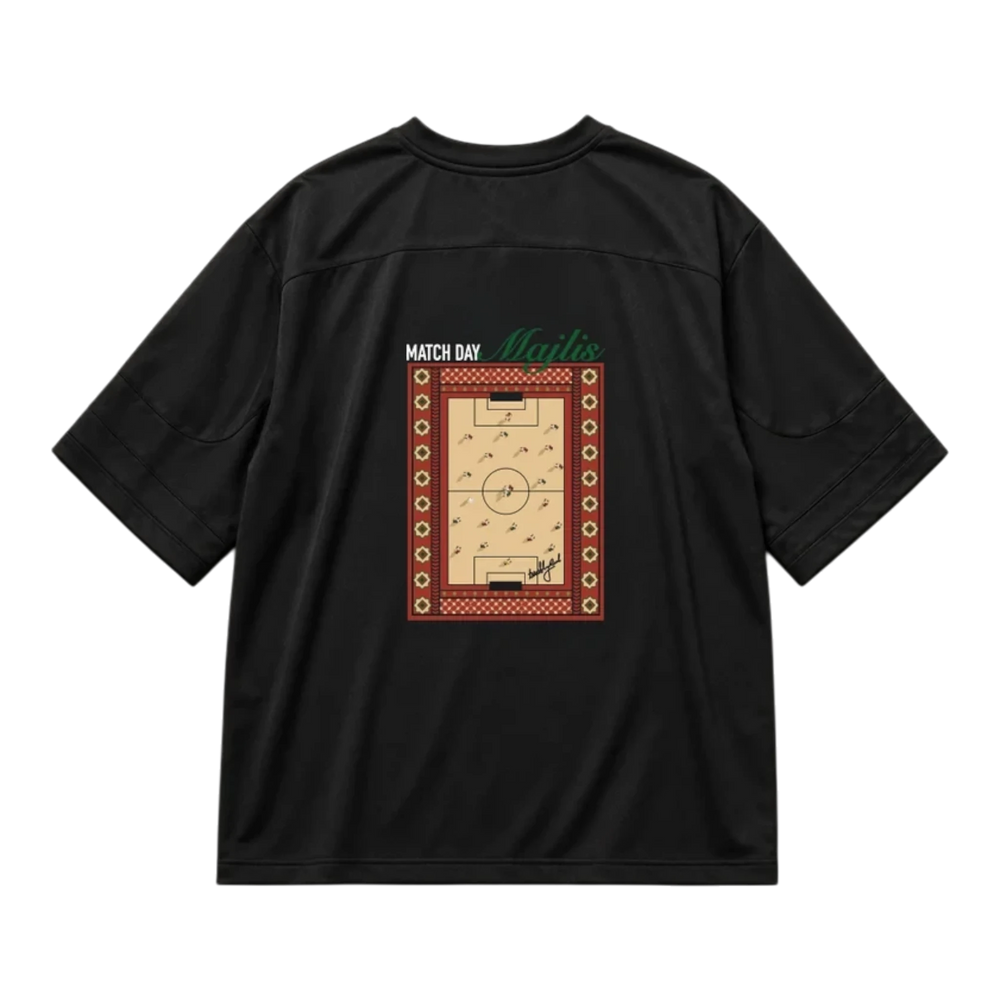 HypeSelection black lifestyle jersey featuring a back graphic of a football pitch with traditional Majlis patterns.