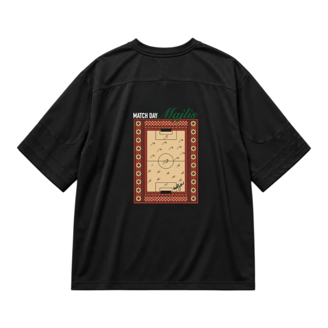 HypeSelection black lifestyle jersey featuring a back graphic of a football pitch with traditional Majlis patterns.