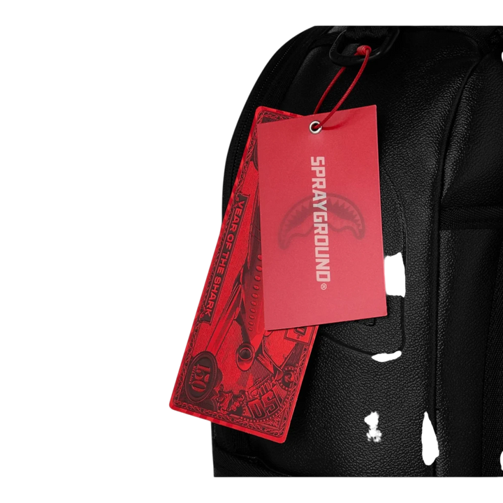 HypeSelection black faux leather backpack with red tags featuring gold brick graphic and shark logo.