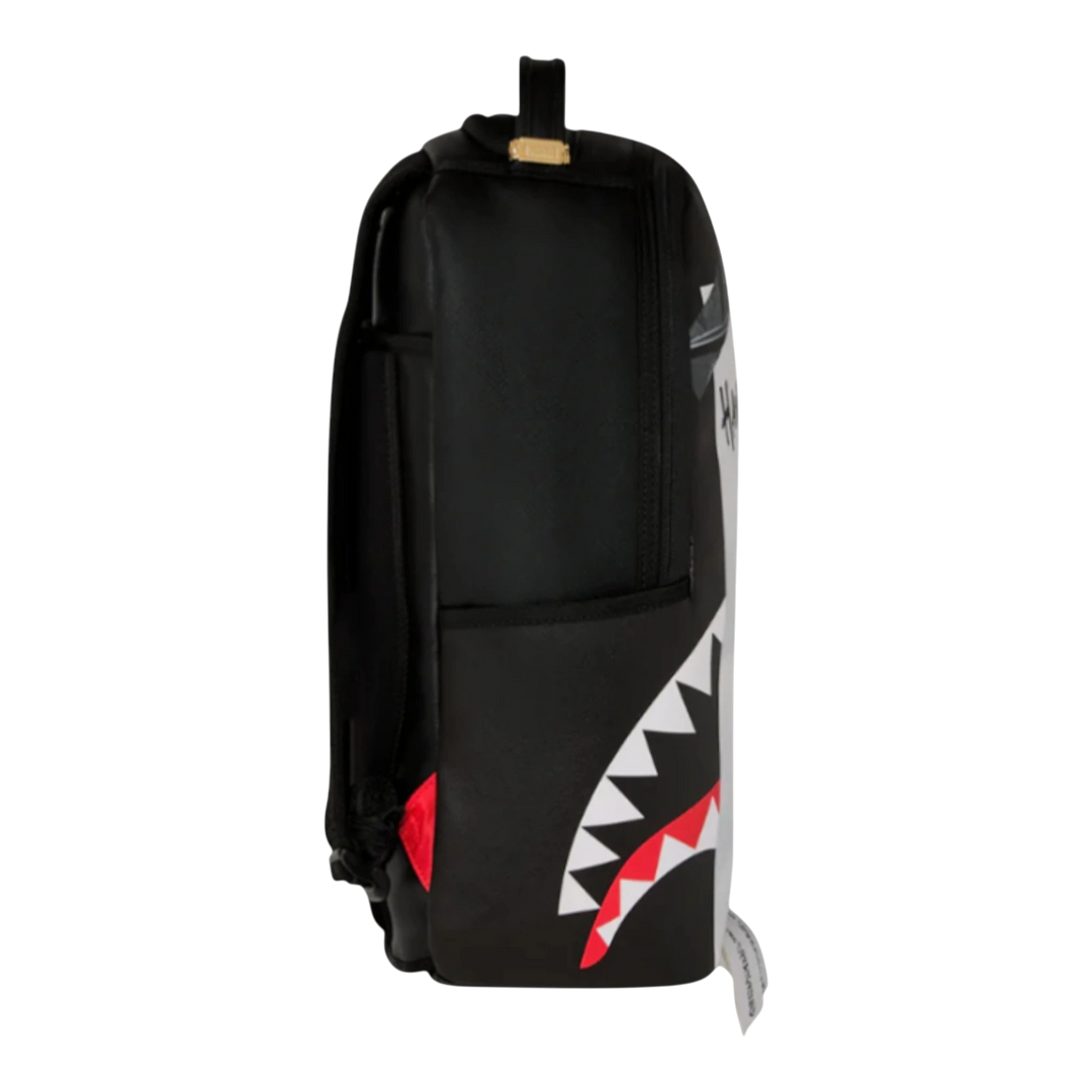 HypeSelection Sprayground black faux leather backpack with multicolor shark mouth graphic and red accents.