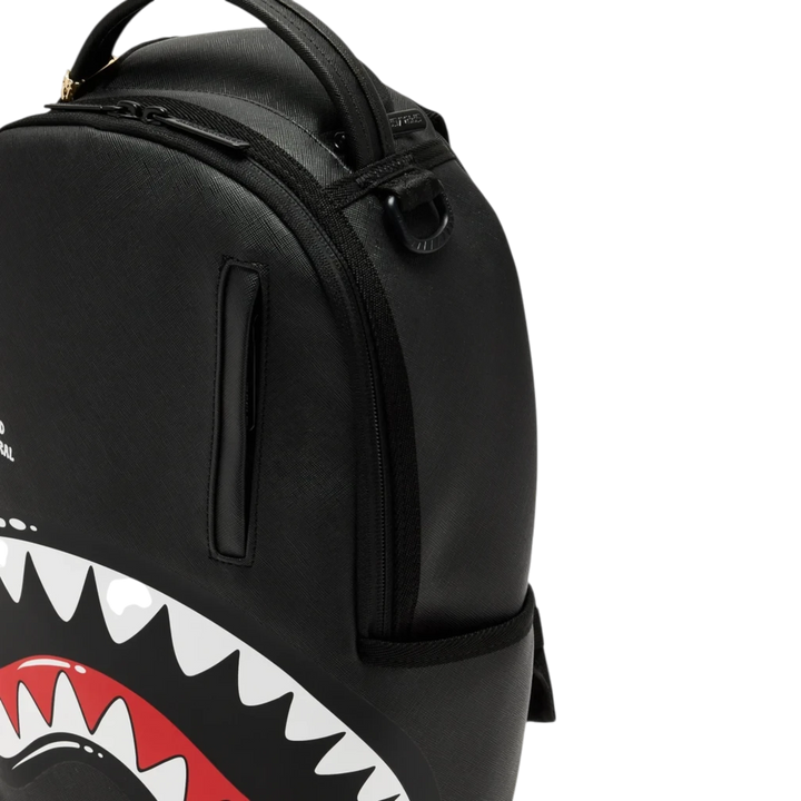 HypeSelection black Sprayground Toon Shark mini backpack with iconic graphic teeth design and top handle.