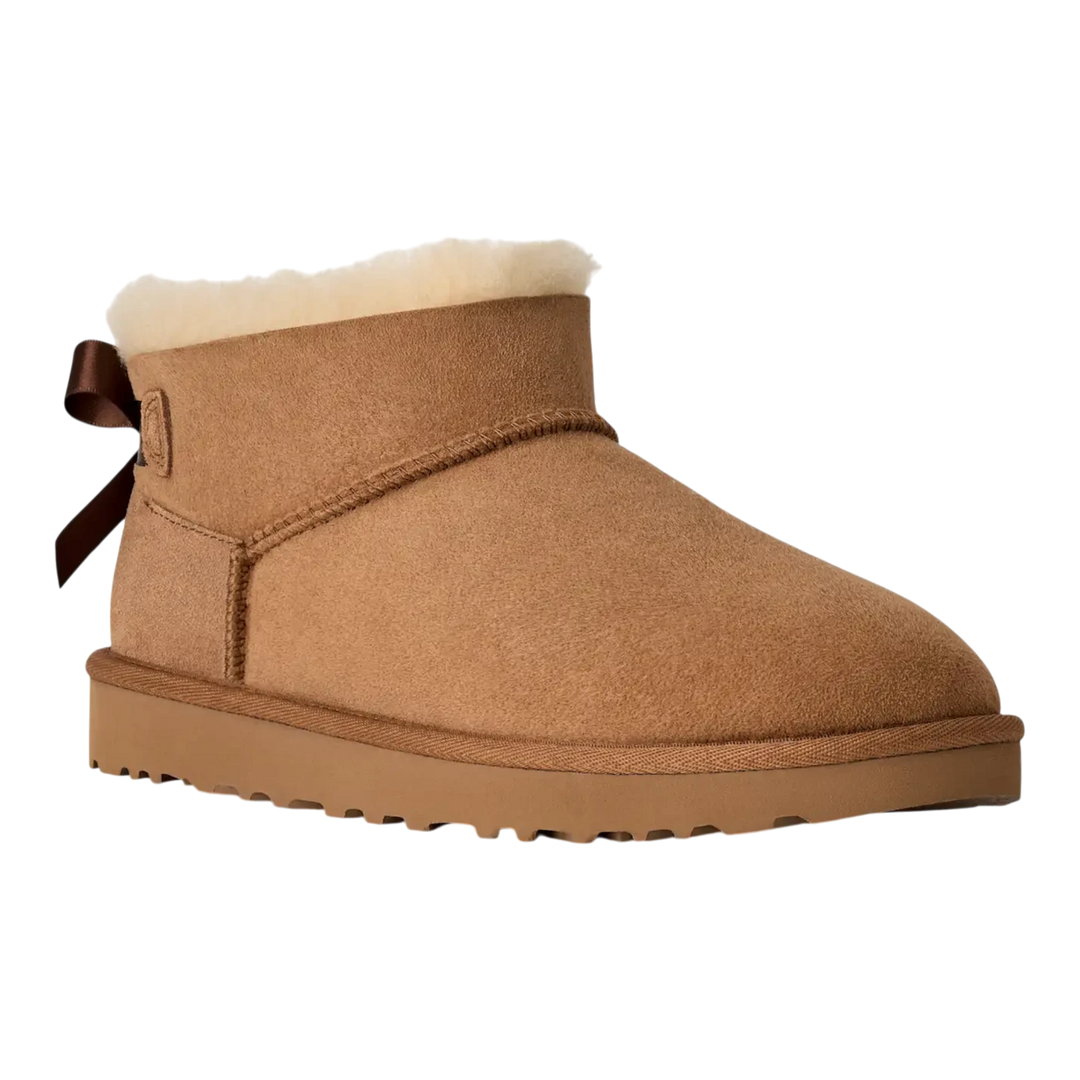 HypeSelection UGG Ultra Mini Bailey Bow boot in chestnut suede with a plush wool lining and back satin bow detail.