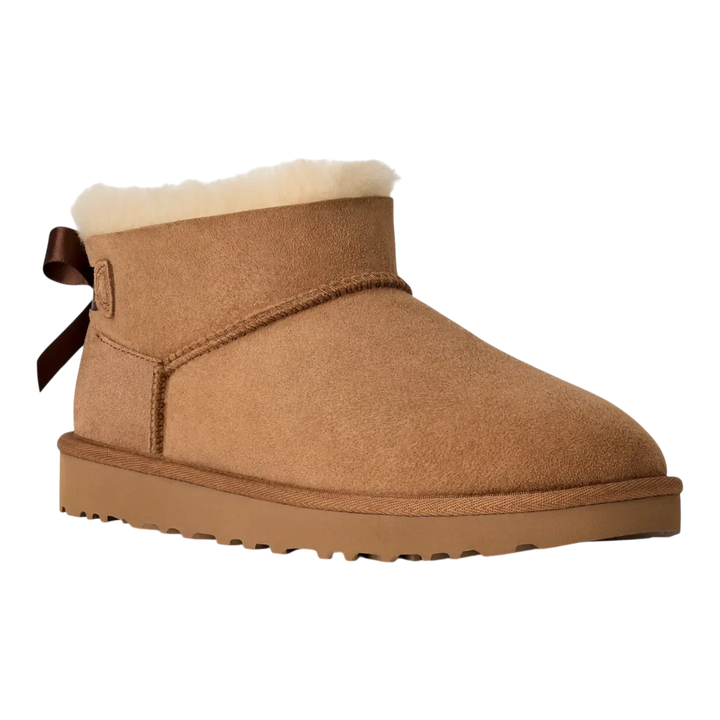 HypeSelection UGG Ultra Mini Bailey Bow boot in chestnut suede with a plush wool lining and back satin bow detail.