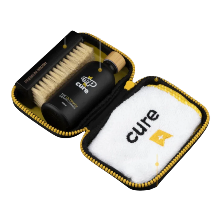 HypeSelection Crep Protect Cure Ultimate Cleaning Kit with cleaning solution, brush, and microfiber cloth in a black and yellow case.
