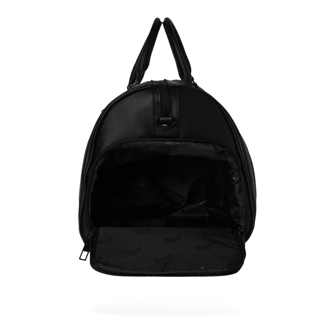 HypeSelection Gold Brick Luxe Duffle, a black eco-leather duffle bag with an all-over gold brick pattern and gold zippers.
