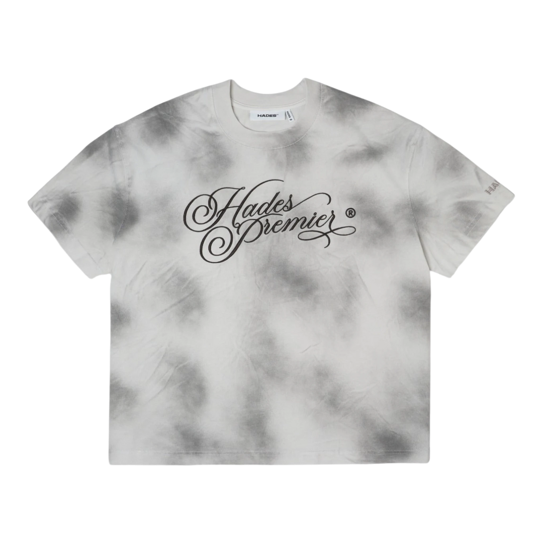 HypeSelection HADES Studio Ash Cloud Tee, a smoke grey tie-dye cotton t-shirt with a black "Hades Premier" graphic print on the front and a small logo on the sleeve.