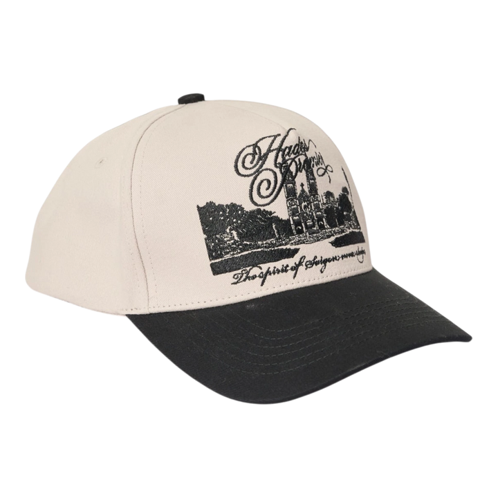 HypeSelection HADES Studio District 1 Cap in white cotton khaki with black brim and embroidered cathedral graphic.