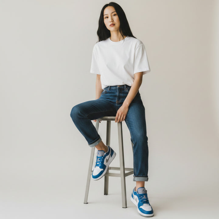 HypeSelection Jordan 1 Low True Blue (GS) sneakers with white leather, blue overlays, grey Swoosh, and perforated toe.
