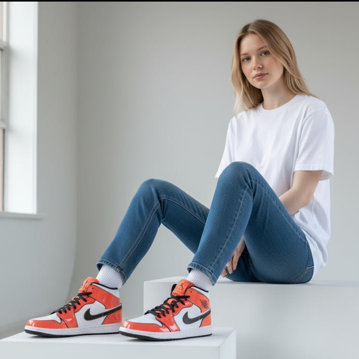 HypeSelection Jordan 1 Mid Turf Orange GS sneakers with white leather base, turf orange overlays, and black accents.