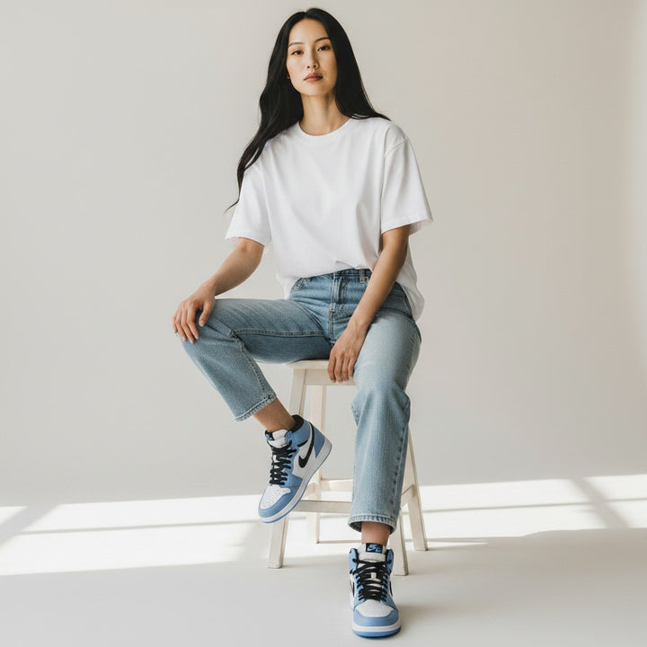 HypeSelection Jordan 1 Retro High OG University Blue GS sneakers with white leather, blue suede overlays, and black accents.