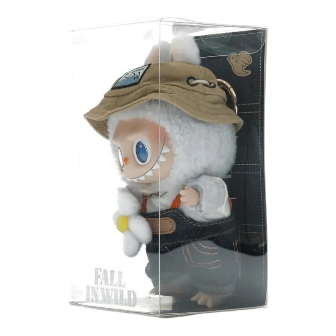 HypeSelection Labubu Fall In Wild plush pendant with vinyl face, wearing denim overalls, bucket hat, and holding a flower.