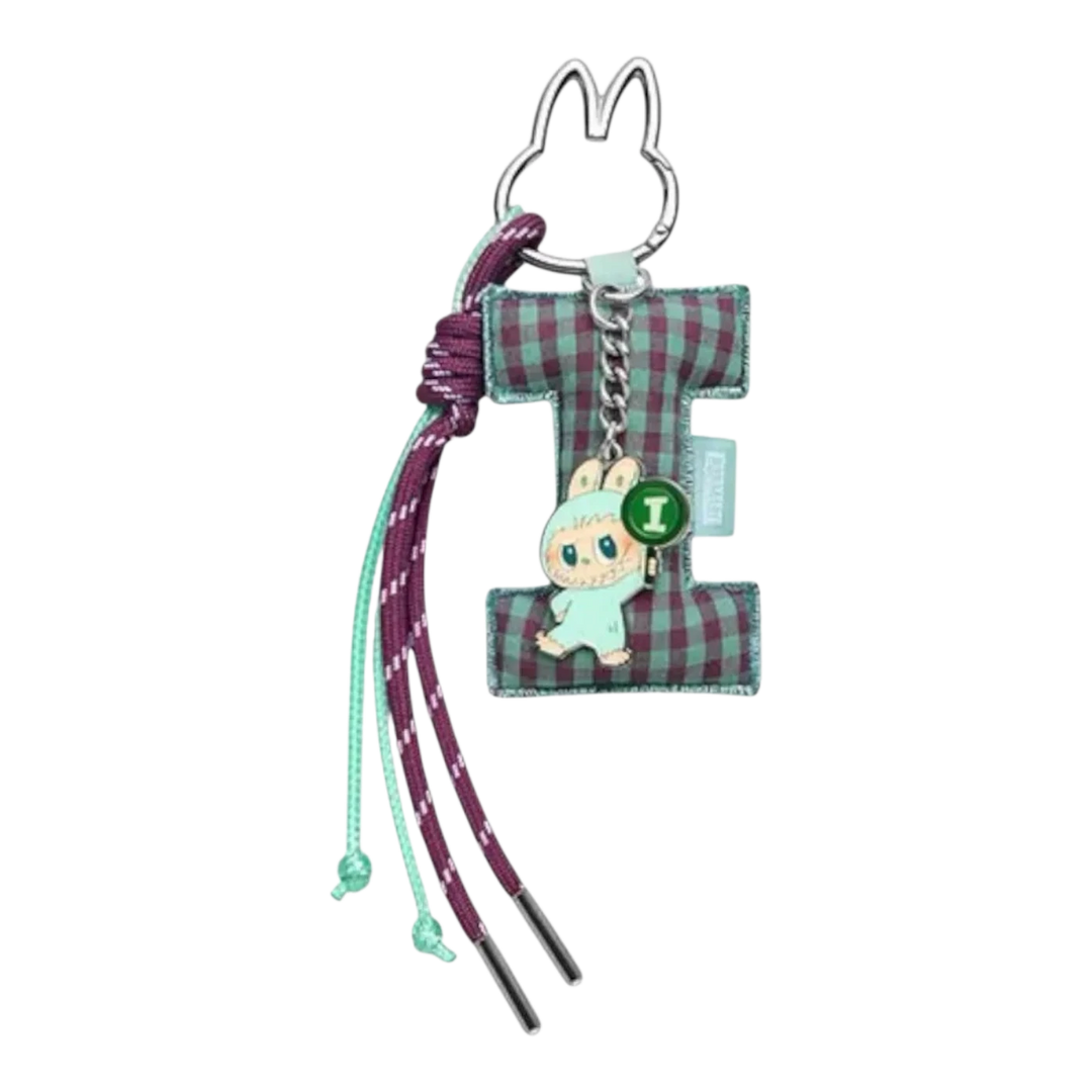 HypeSelection Pop Mart Labubu 'I' letter pendant with green and purple plaid fabric and a small Labubu figure holding an 'I' sign.