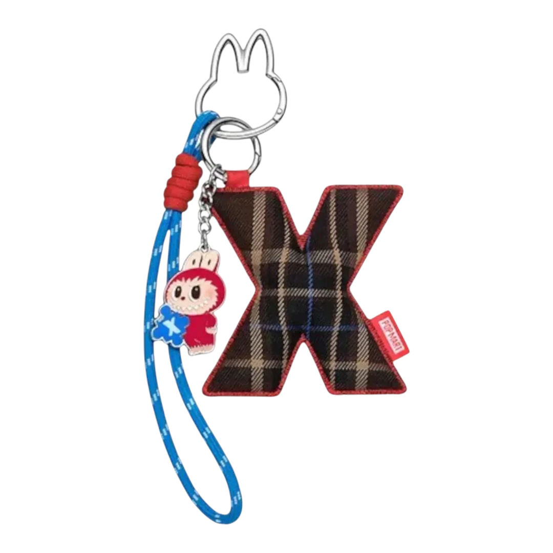 HypeSelection Pop Mart Labubu The Monsters "X" letter pendant with plaid fabric and a small character charm on a blue lanyard.