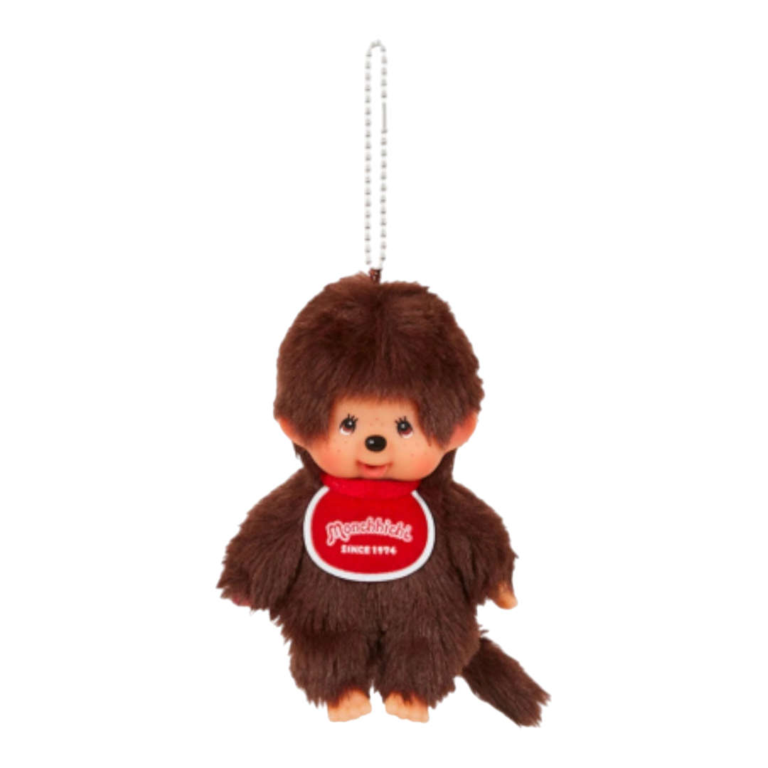 HypeSelection Monchhichi Boy plush keychain with brown fur and a red bib that says "Monchhichi Since 1974".