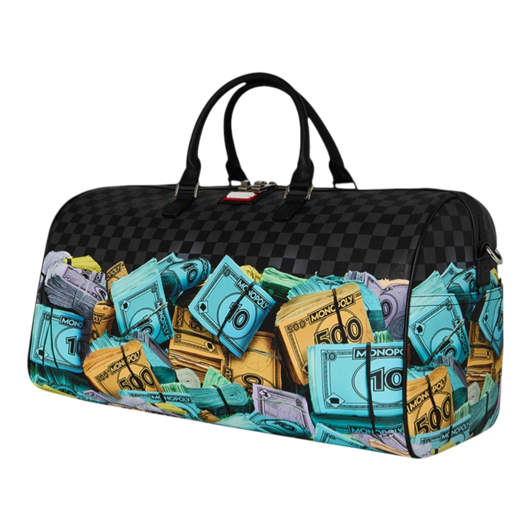 HypeSelection duffle bag with all-over Monopoly money stacks graphic print, black checkerboard pattern, and dual handles.