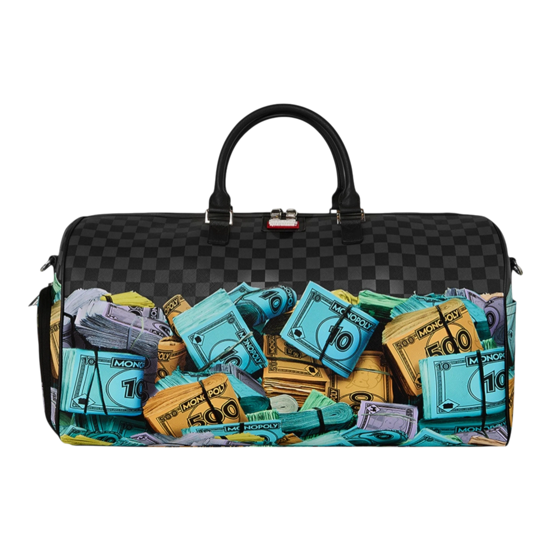 HypeSelection duffle bag with all-over Monopoly money stacks graphic print, black checkered pattern, and dual handles.
