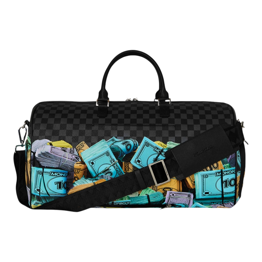 HypeSelection duffle bag with all-over Monopoly money stacks graphic print, black checkered pattern, and black straps.