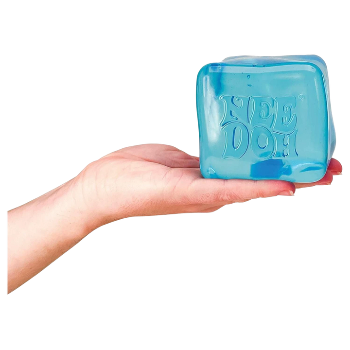 HypeSelection NeeDoh Nice Cube Big sensory toy in translucent blue, held in a hand. Features slow-rebound texture.