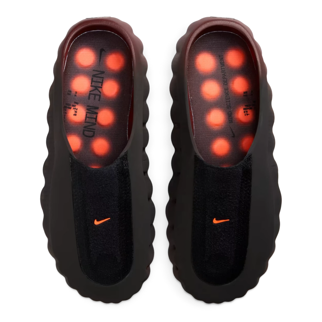 HypeSelection Nike Mind 001 Flyknit slides in Bronze Eclipse with black upper and vibrant Total Orange footbed nodes.