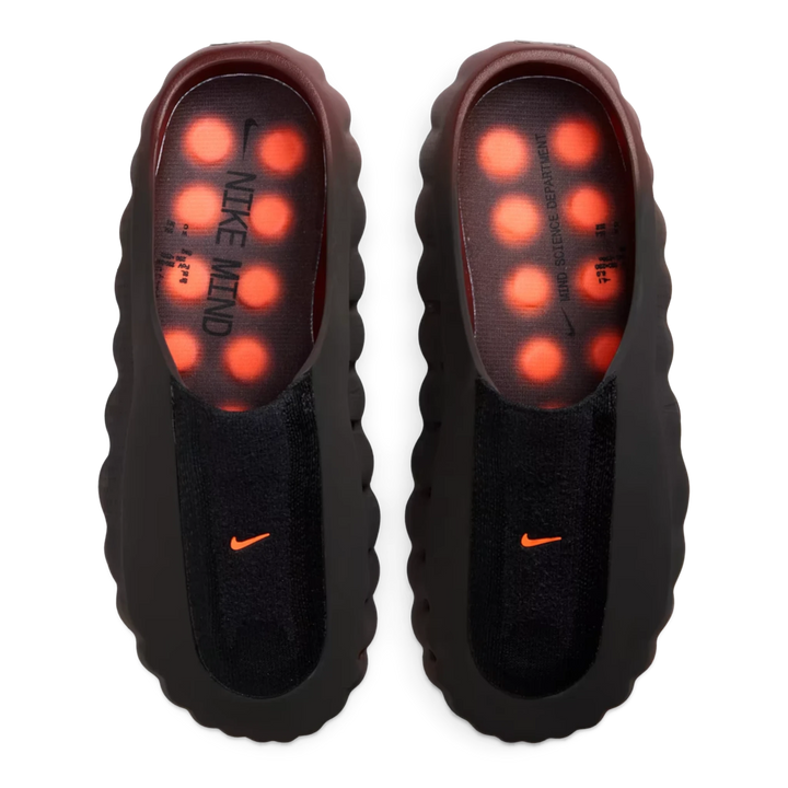 HypeSelection Nike Mind 001 Flyknit slides in Bronze Eclipse with black upper and vibrant Total Orange footbed nodes.