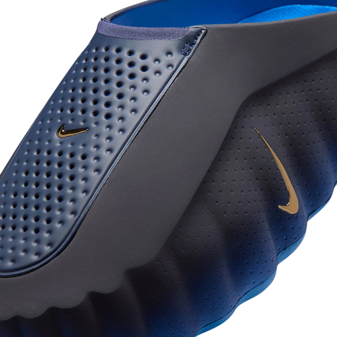 HypeSelection Nike Mind 001 Slide in Blackened Blue and Game Royal foam with perforated details and gold Nike logos.