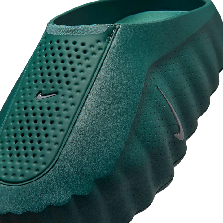 Nike Mind 001 Slide in Mineral Slate green, featuring a perforated upper and a unique 22-node outsole for sensory feedback.