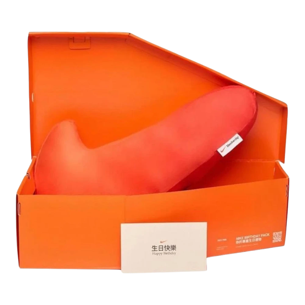 HypeSelection orange Nike Swoosh shaped pillow, a plush collectible from the limited "Birthday Pack" collection.