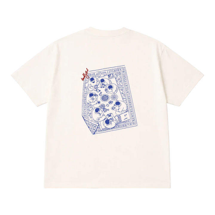 HypeSelection off-white cotton t-shirt with a blue graphic print of people sharing a meal on a rug.