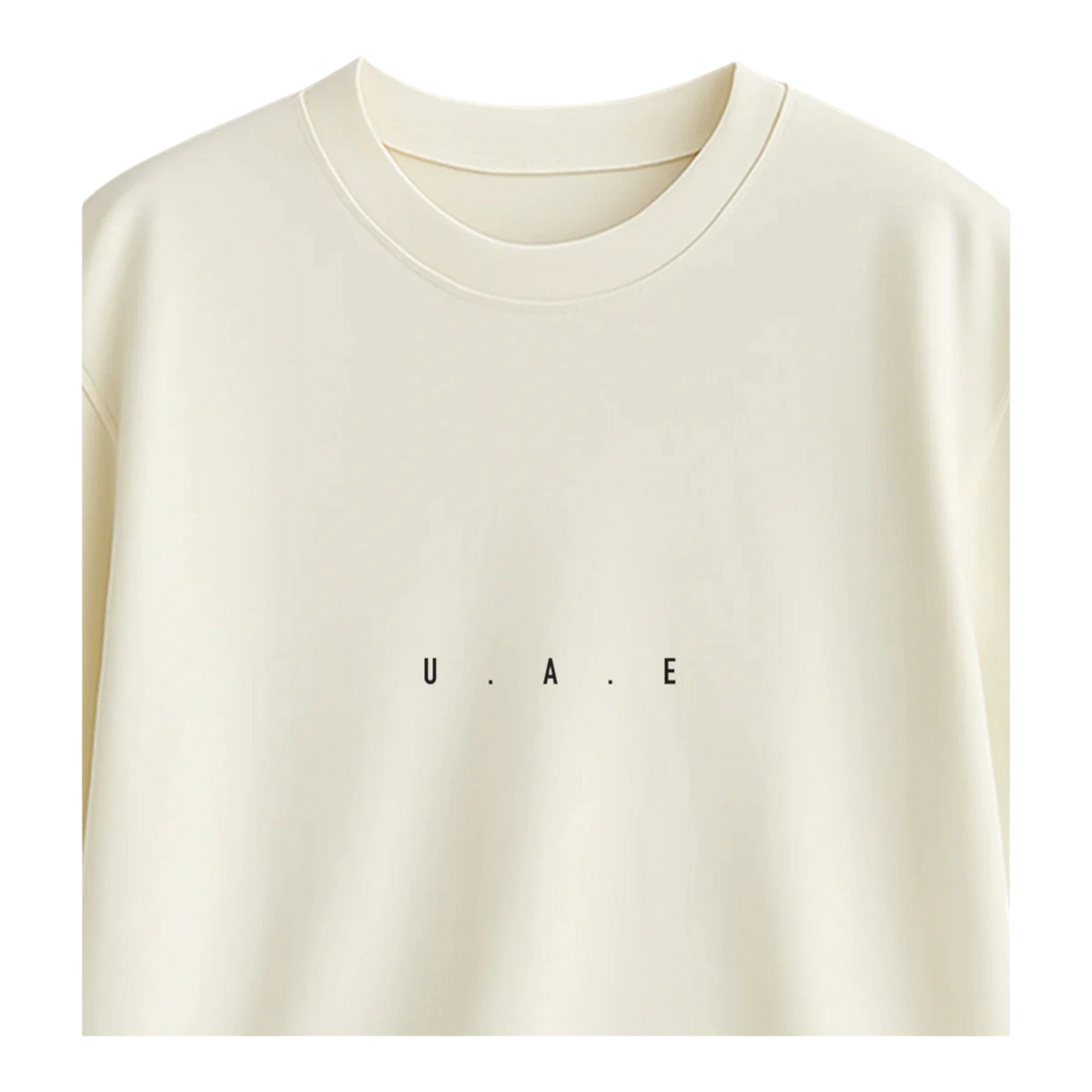 HypeSelection off-white terry cotton oversized t-shirt with minimalist "U.A.E." print on chest.