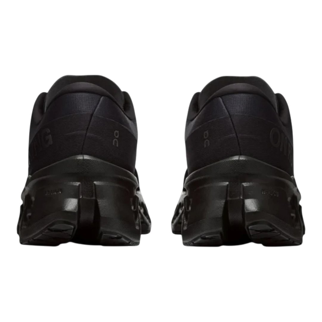 HypeSelection pair of all-black On Cloudmonster 3 running shoes viewed from the back showing the thick CloudTec midsole