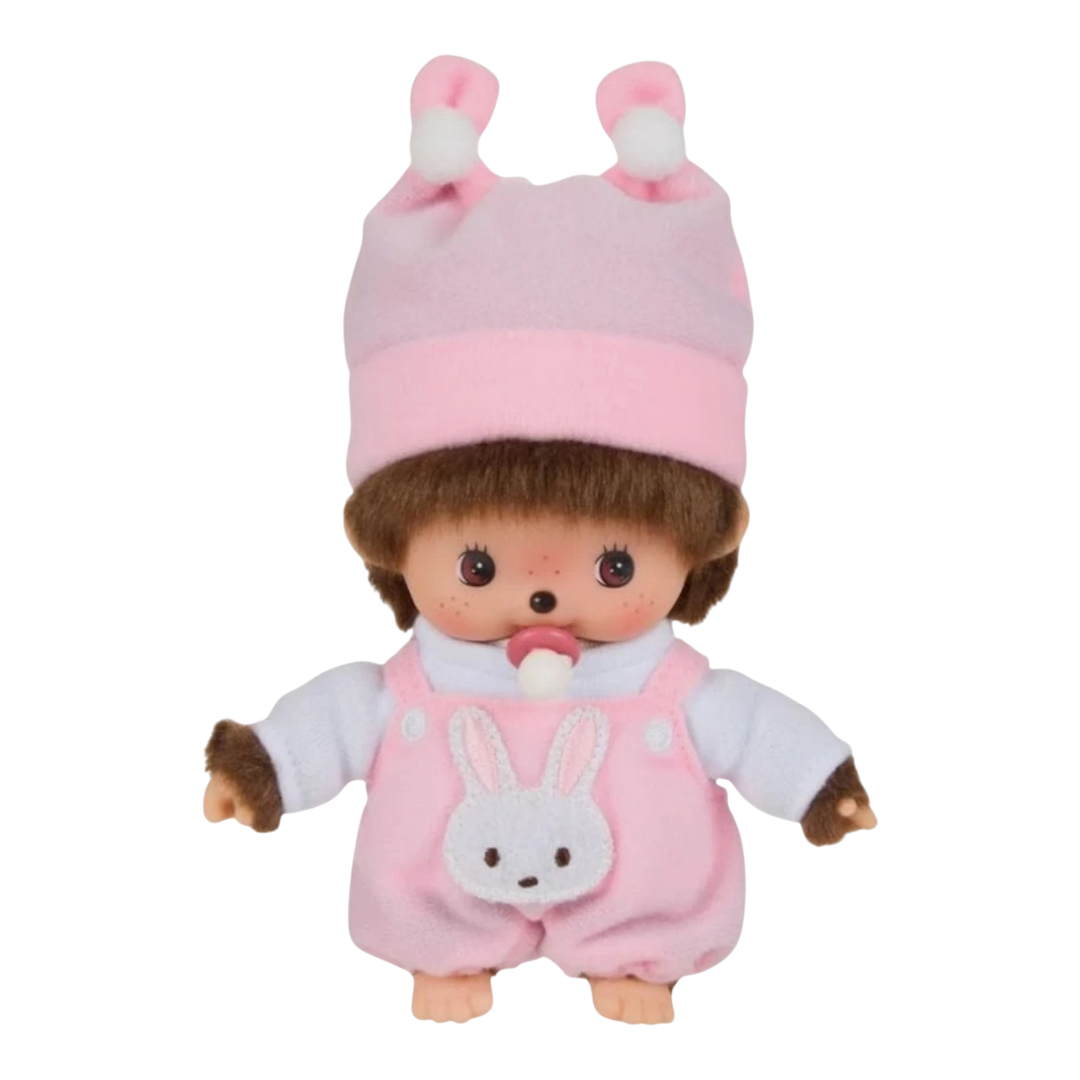 HypeSelection pink plush Monchhichi Babychhichi doll in a bunny-themed outfit with a pacifier, wearing a hat with pom-poms.