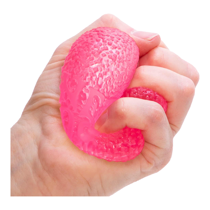 HypeSelection pink NeeDoh Gumdrop sensory fidget toy with a textured, jelly-filled surface being squeezed in a hand.