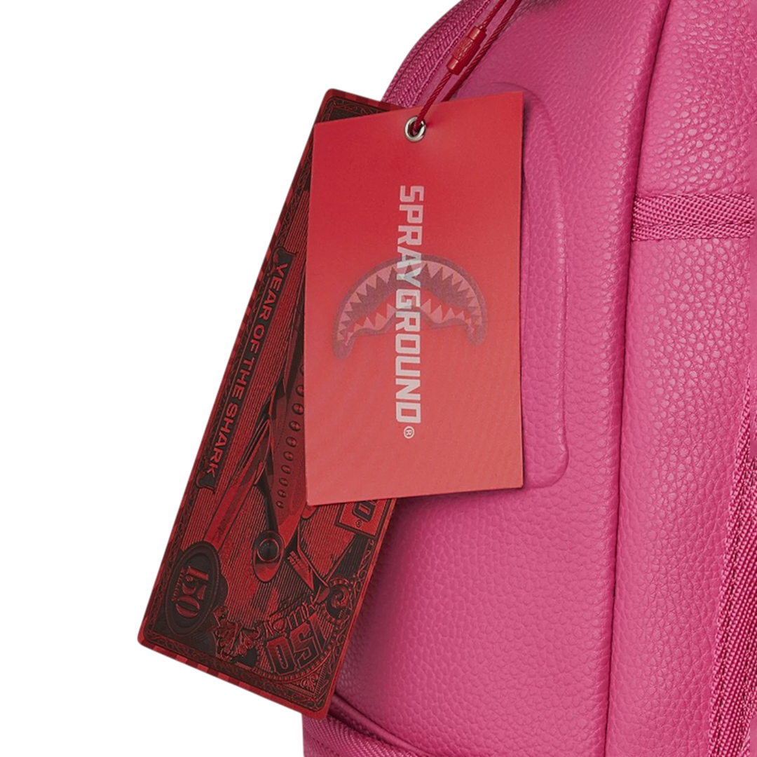 HypeSelection pink faux leather backpack with iconic shark mouth graphic and red tags.