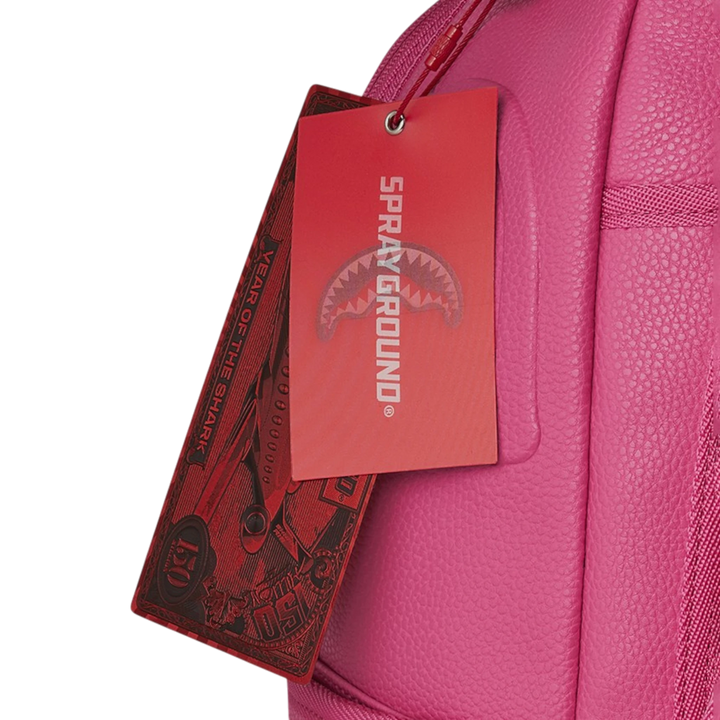 HypeSelection pink faux leather backpack with iconic shark mouth graphic and red tags.