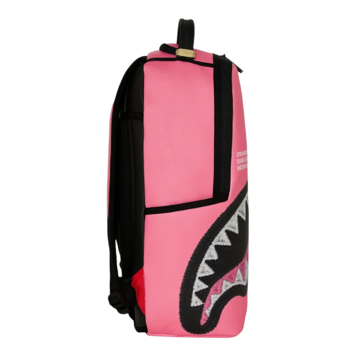 HypeSelection pink Sprayground Shark Central backpack with signature embroidered shark mouth graphic side view