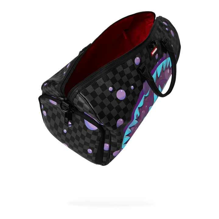 HypeSelection Purple Slime Takeover duffle bag with black checkerboard pattern, purple slime drips, and shark graphic.