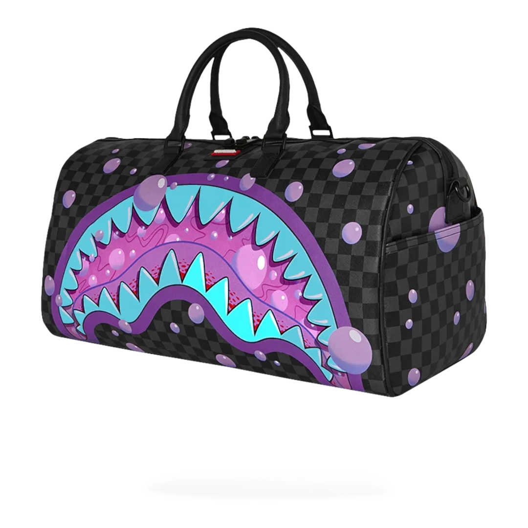 HypeSelection Purple Slime Takeover duffle bag with shark mouth graphic, faux leather, gold zippers, and purple bubble accents.