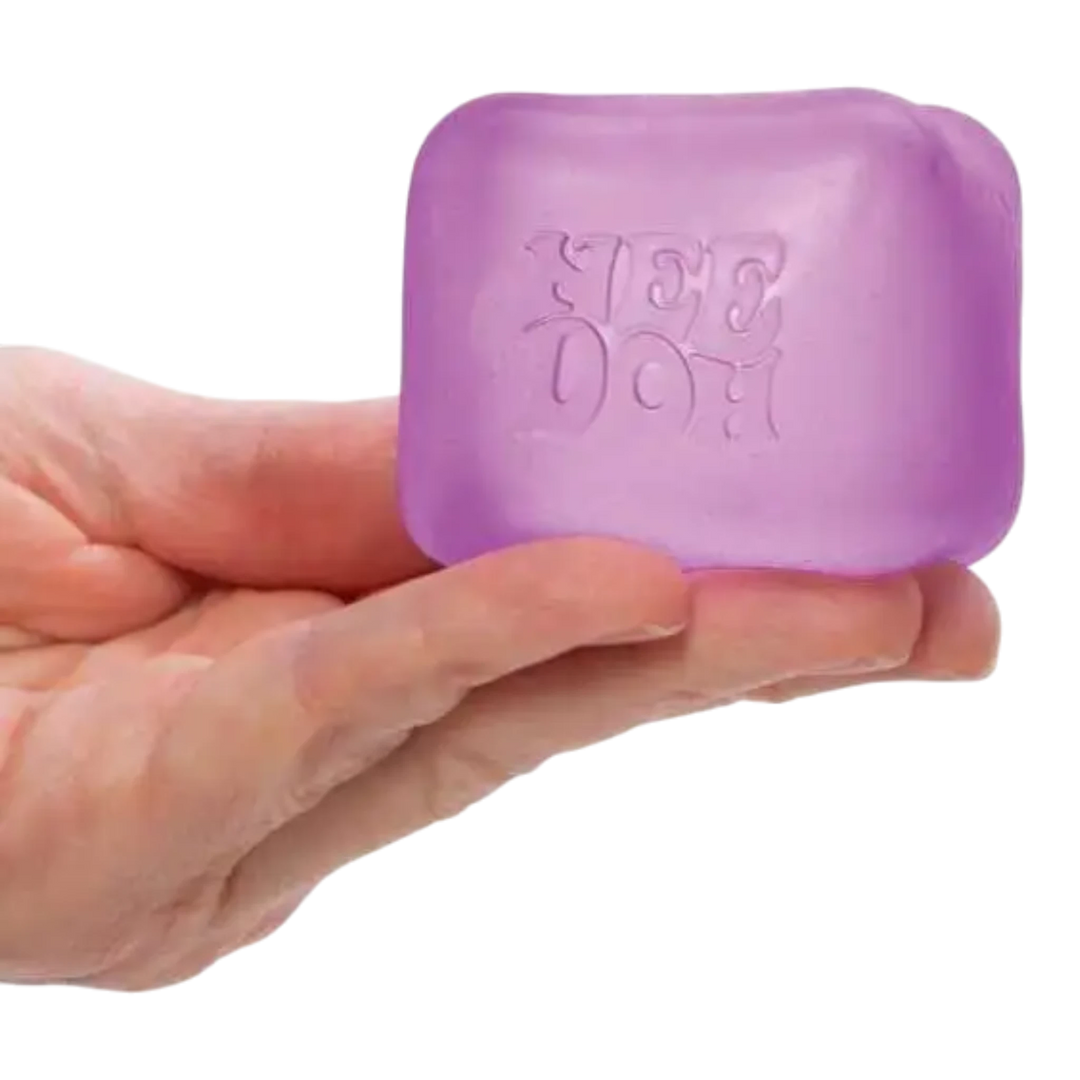 HypeSelection NeeDoh Nice Cube squishy fidget toy in translucent purple, held in a hand. Cube shape with slow-squish texture.