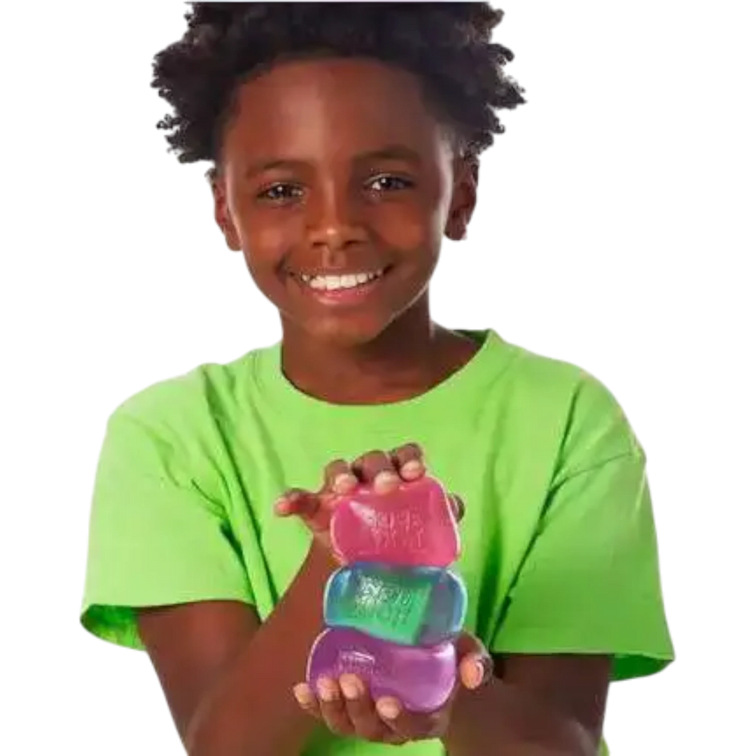NeeDoh Nice Cube squishy fidget toy stack in purple, green, and pink, held by a smiling child.
