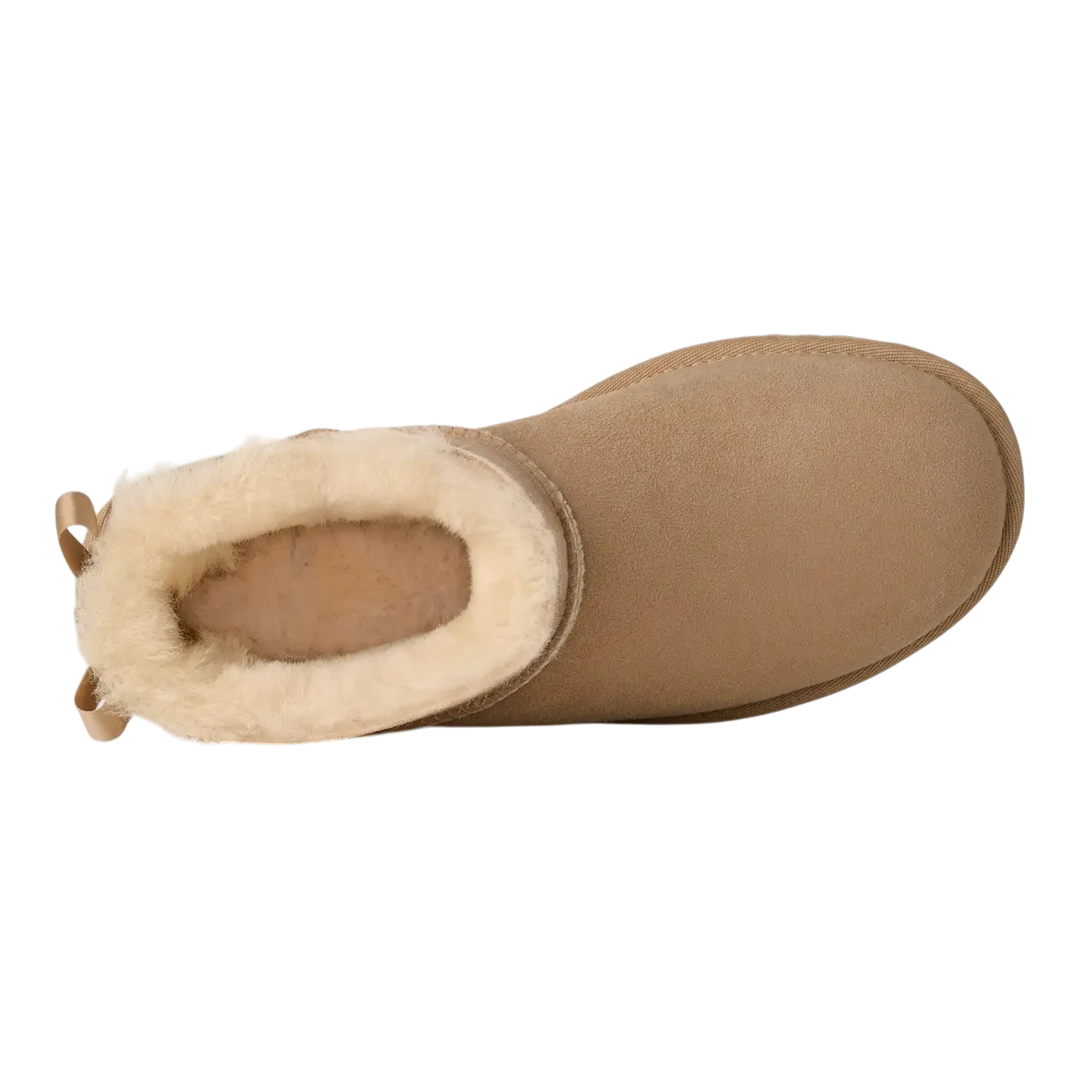HypeSelection UGG Ultra Mini Bailey Bow boot in sand suede with plush wool lining and back satin bow, top view