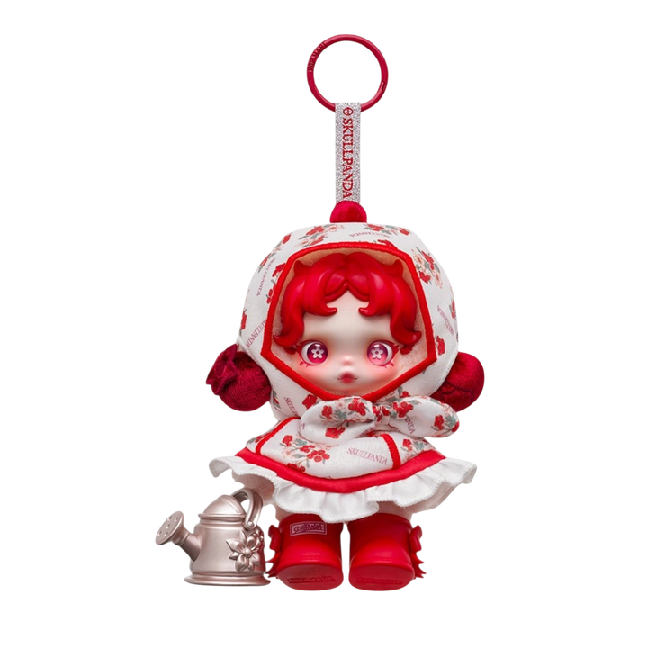HypeSelection SKULLPANDA Amid Flowers plush doll pendant with red hair, floral print dress, and red boots, holding a watering can.