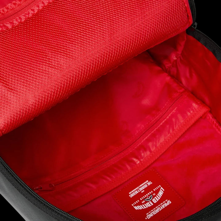 HypeSelection Sprayground Lux Black Ghost Drip backpack interior featuring vibrant red lining and branded patch