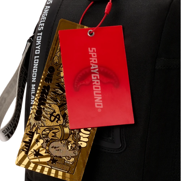 HypeSelection Sprayground backpack featuring a red branded tag and a gold graphic card on a black fabric background