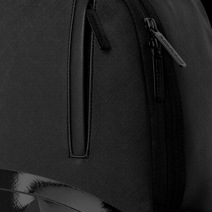 HypeSelection Sprayground Lux Black Ghost Drip backpack featuring textured black material and branded zipper pulls